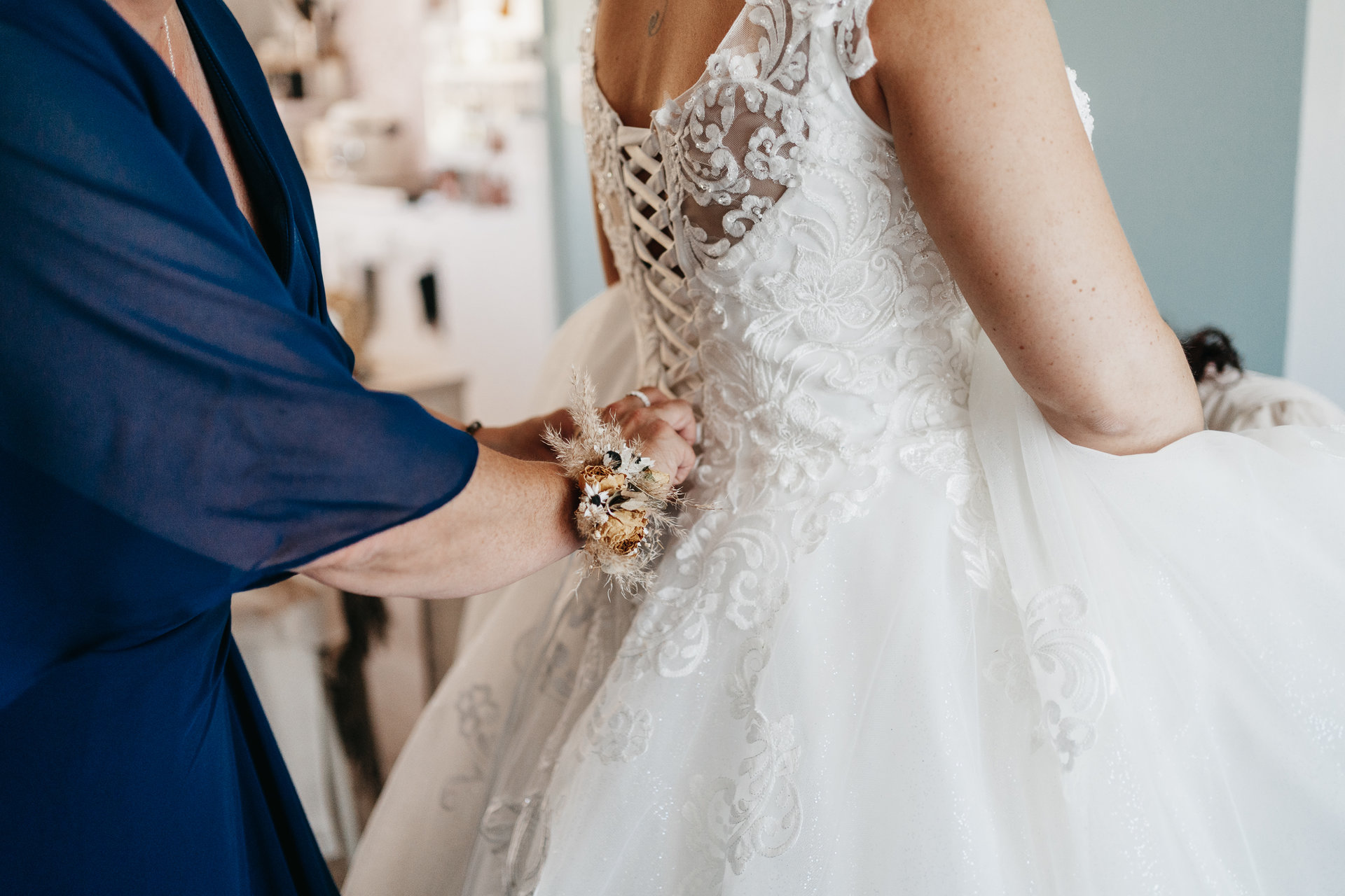 Une femme enfilant la robe de mariée d'une mariée.